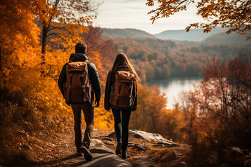 a couple hiking in the mountains with fall foliage in the blurred background