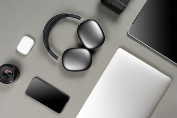 Mockup set of modern gadgets on a beautiful sky blue or blue background with headphones, laptop, phone, joystick and camera
