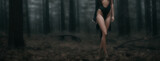 sexy woman in lingerie posing in the forest. girl with naked body