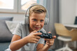 © cherryandbees - Young Caucasian boy enjoys playing video games with joystick.