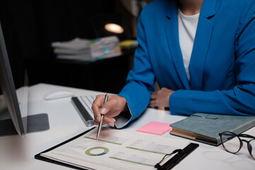 Wall Mural - Asian businesswoman working inside the office at night