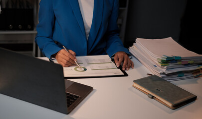 Poster - Asian businesswoman working inside the office at night