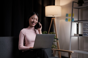 Poster - Young Asian woman talking on mobile phone at night in her house.