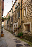 Fototapeta Na drzwi - A residential street in the historic coastal village of Kastel Gomilica in Kastela, Croatia