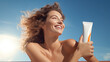 © Studio Nova - A beautiful young woman on a sunny beach holding sunscreen against blue sky. Created with Generative AI technology.