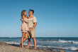 © sutulastock - boyfriend and girlfriend husband and wife on vacation at sea have fun hugging and laughing on the beach near the sea