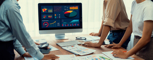 Leinwandbilder - Panorama shot analyst team utilizing BI Fintech to analyze financial report with laptop. Businesspeople analyzing BI power dashboard displayed on laptop screen for business insight. Scrutinize