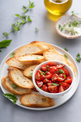 Wall Mural - Making tomato basil bruschetta with toasted baguette and herbs