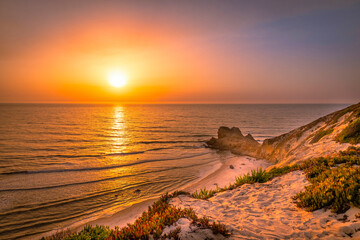 Beautiful sunset at the beach. Sunset at the portuguese beach of Paredes Vitória - Nazaré - Portugal