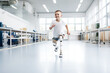 Happy Child disabled boy with prostheses instead of legs trains in a rehabilitation center.