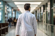 Back view of a doctor walking in a hospital ward