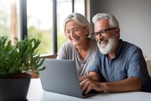 Mature Couple Smiling And Looking At Laptop At Home