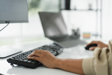 Hands of developer programmer using mouse and typing on keyboard to programming and developing web