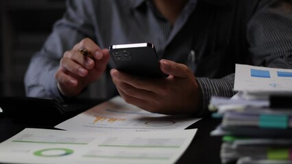 Businessman using smartphones on their desks in the office.