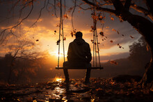 Silhouette Of A Person Sitting On A Swing