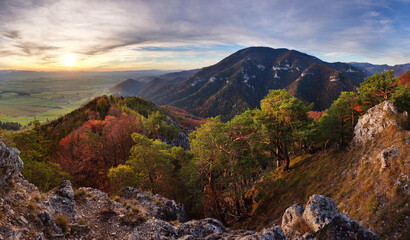 Canvas Print - panorama landscape at sunset with autumn forest, rocks, sun and mountain.