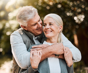 Wall Mural - Love, hug and senior couple at a park happy, free and enjoy travel, holiday or weekend outdoor. Face, smile and elderly man embrace woman in forest, bond and having fun on retirement trip together