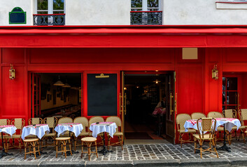 Wall Mural - cozy street with tables of cafe in quarter montmartre in paris, france. architecture and landmark of