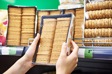 Poster - Packets of cookies in hands of buyer