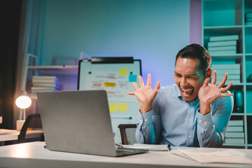 business man working late at night use laptop at desk Happy male portrait working IT, face and male coder or person programming Coding and Writing for Software or Information Technology Development