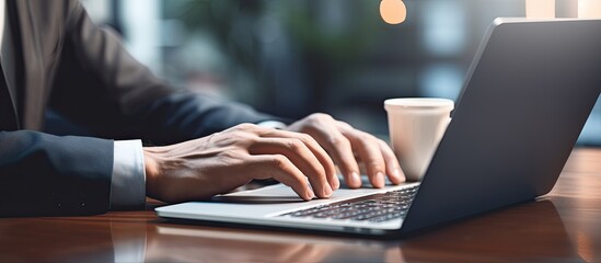 Fototapete - Man using laptop with empty screen for advertising text message in office