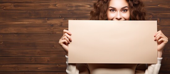Aufkleber - Humorous image of a happy girl with an empty white sign on a brown background