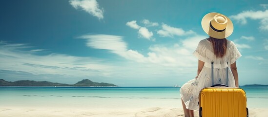 Poster - Summer vacation and travel concept Young woman traveler on tropical beach relaxing with luggage
