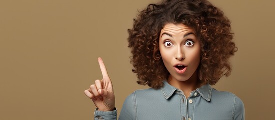 Poster - Excited woman points to side and upwards indicating copy space for your concept