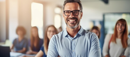 Mature teacher posing happily with students studying