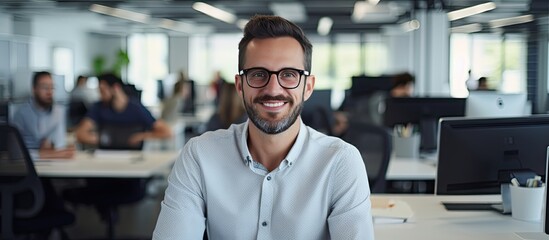 Leinwandbilder - Smiling male software developer at work in office ample space