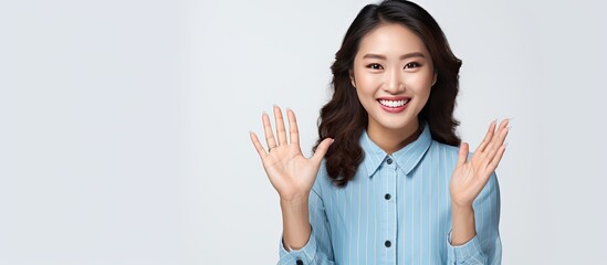 Poster - Asian woman displaying an open hand prompt with room for product on white backdrop