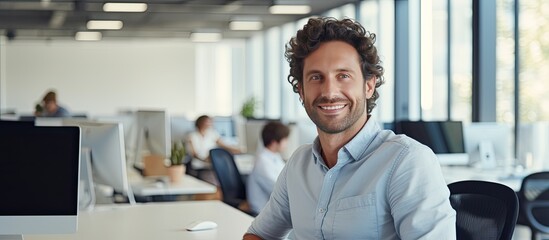 Leinwandbilder - Smiling male software developer at work in office ample space