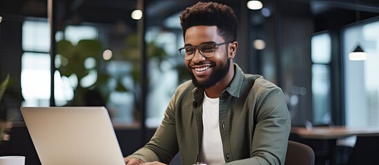 Leinwandbilder - Close up of smiling African American freelancer typing on laptop enjoying remote job