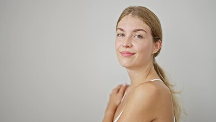 Wall Mural - Young blonde woman smiling confident standing over isolated white background