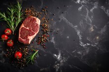 Beef Steak With Spices On Dark Stone Background