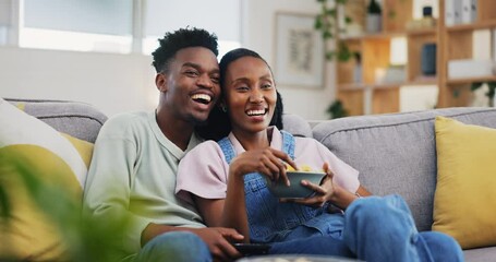 Poster - Happy, relax and a black couple with chips while watching tv, comedy show or film on the sofa. Smile, laughing and an African man and woman with food, streaming movie and together in a house