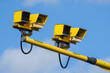 Yellow traffic speed control cameras on a road