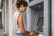 © Miljan Živković - woman using credit card and withdrawing cash at the ATM