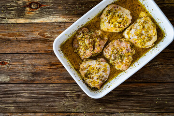 Wall Mural - Marinated raw chicken thighs in baking dish prepared to roast
