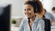 Happy young woman in call center with headset and CRM, providing customer service with a smile