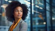 © brillianata - Beautiful black woman against blurred office background. Modern business lady.