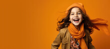 Cute Young Happy Girl In Scarf And Hat For Fall On A Orange Background With Space For Copy