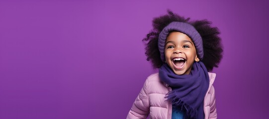 Wall Mural - Cute Young African American Girl in Scarf and Hat for Winter on a Purple Background with Space for Copy