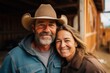 © Baba Images - Middle aged caucasian couple living on a ranch in the countryside in the USA smiling portrait