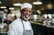 © Baba Images - Middle aged african american chef working in a restaurant kitchen