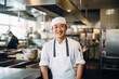© Baba Images - Middle aged chinese chef working and preparing food in a restaurant kitchen smiling portrait