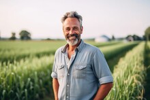 Portrait Of A Smilimg Middle Aged Caucasian Farmer On His Farm Field