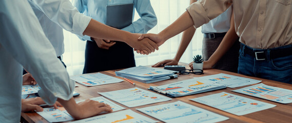 Leinwandbilder - Analyst team celebrates successful data analysis with handshake. Panorama shot handshaking after adjusting attitude or brainstorm for future success in meeting room with BI dashboard paper. Scrutinize