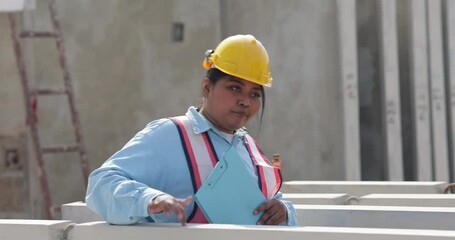 Wall Mural - African american women foreman checking quality of prefabricated concrete wall. Plus size female worker wearing safety hardhat working at heavy Prefabricated concrete walls manufacturing factory