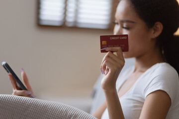 Young African woman smartphone with credit card at home, Online Shopping.